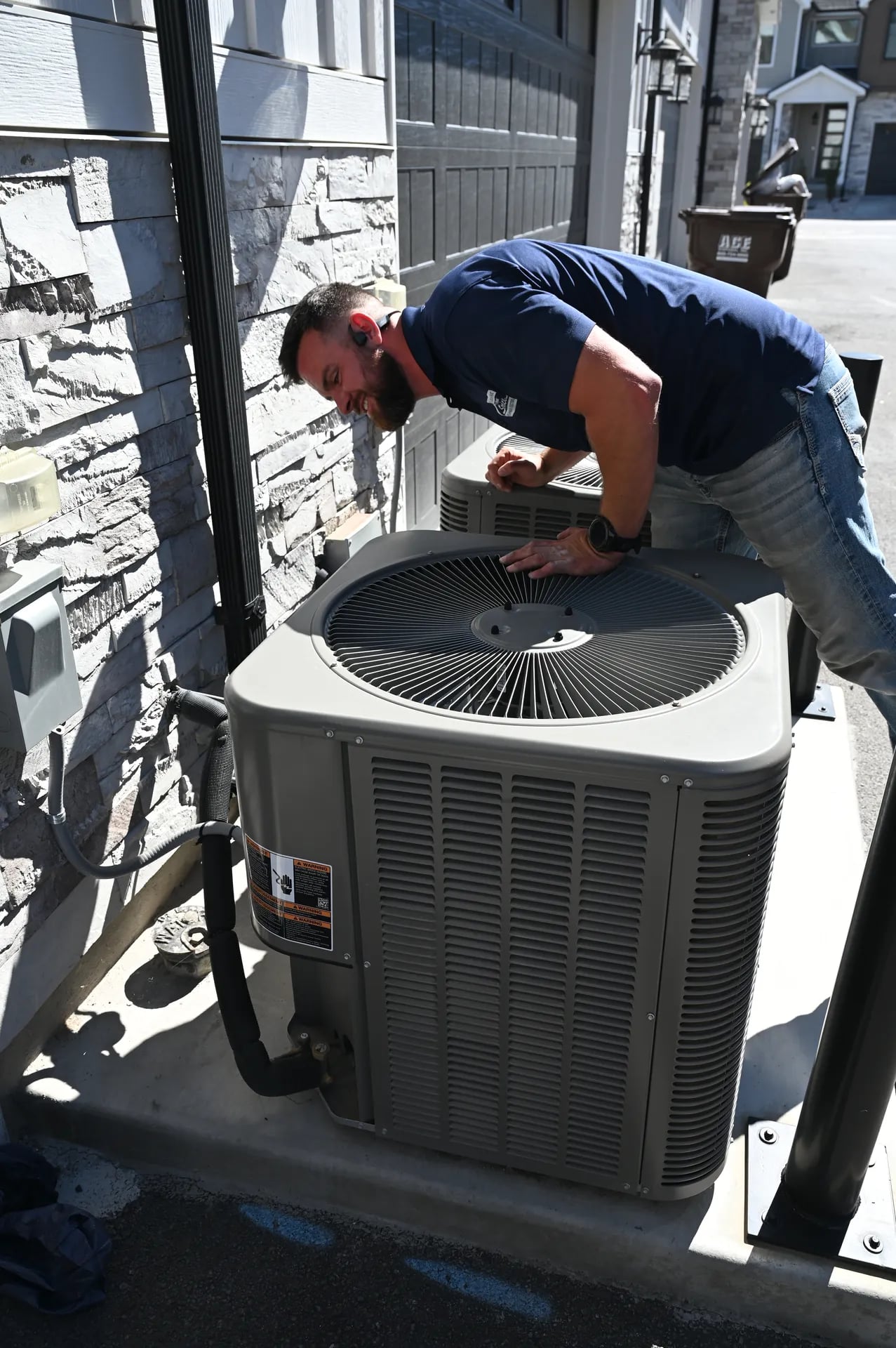 Technician servicing premium AC condenser