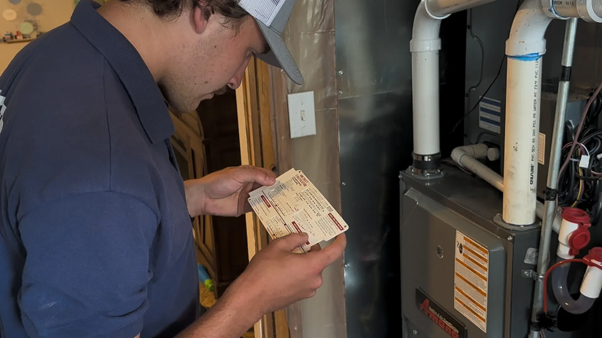 AYSP technician diagnosing a furnace flame sensor and burner assembly