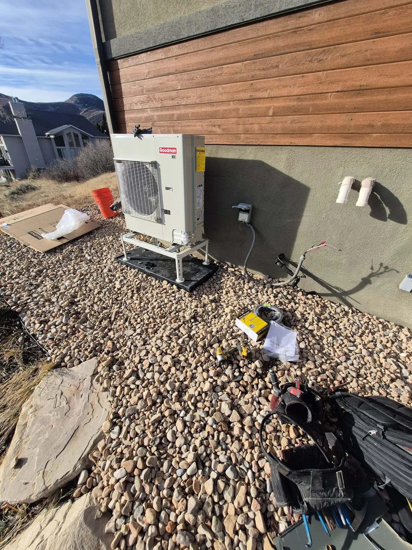 Heat pump install with mountain backdrop