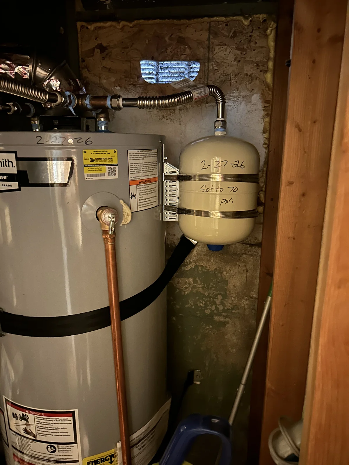 Expansion tank and water heater install by our plumbing crew — pan, straps, and code items done right