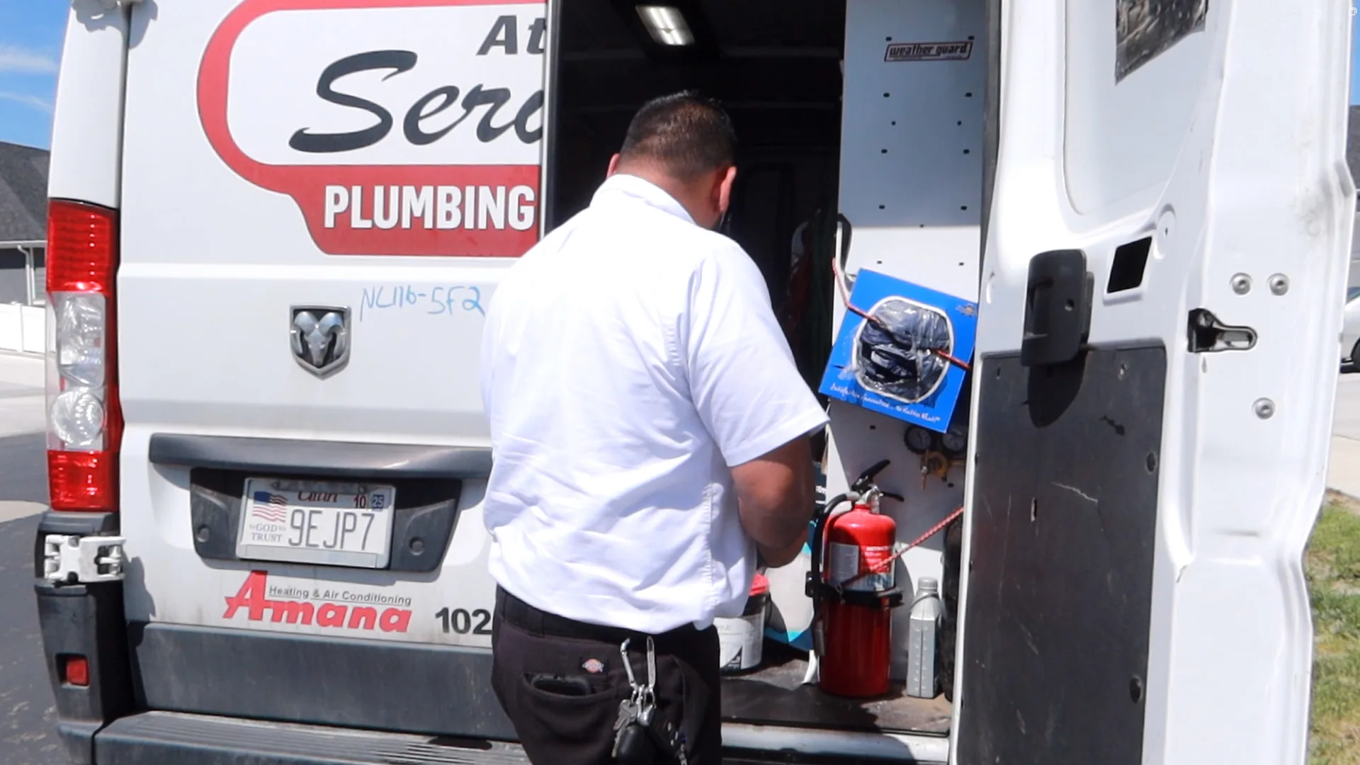 Technician getting tools from service van